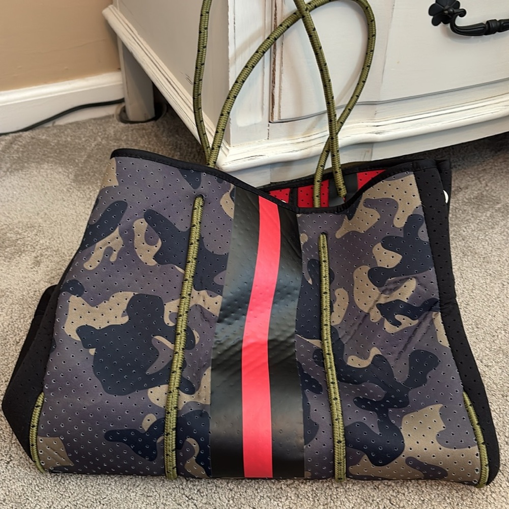 Camouflage bag with black and red stripe. Used once